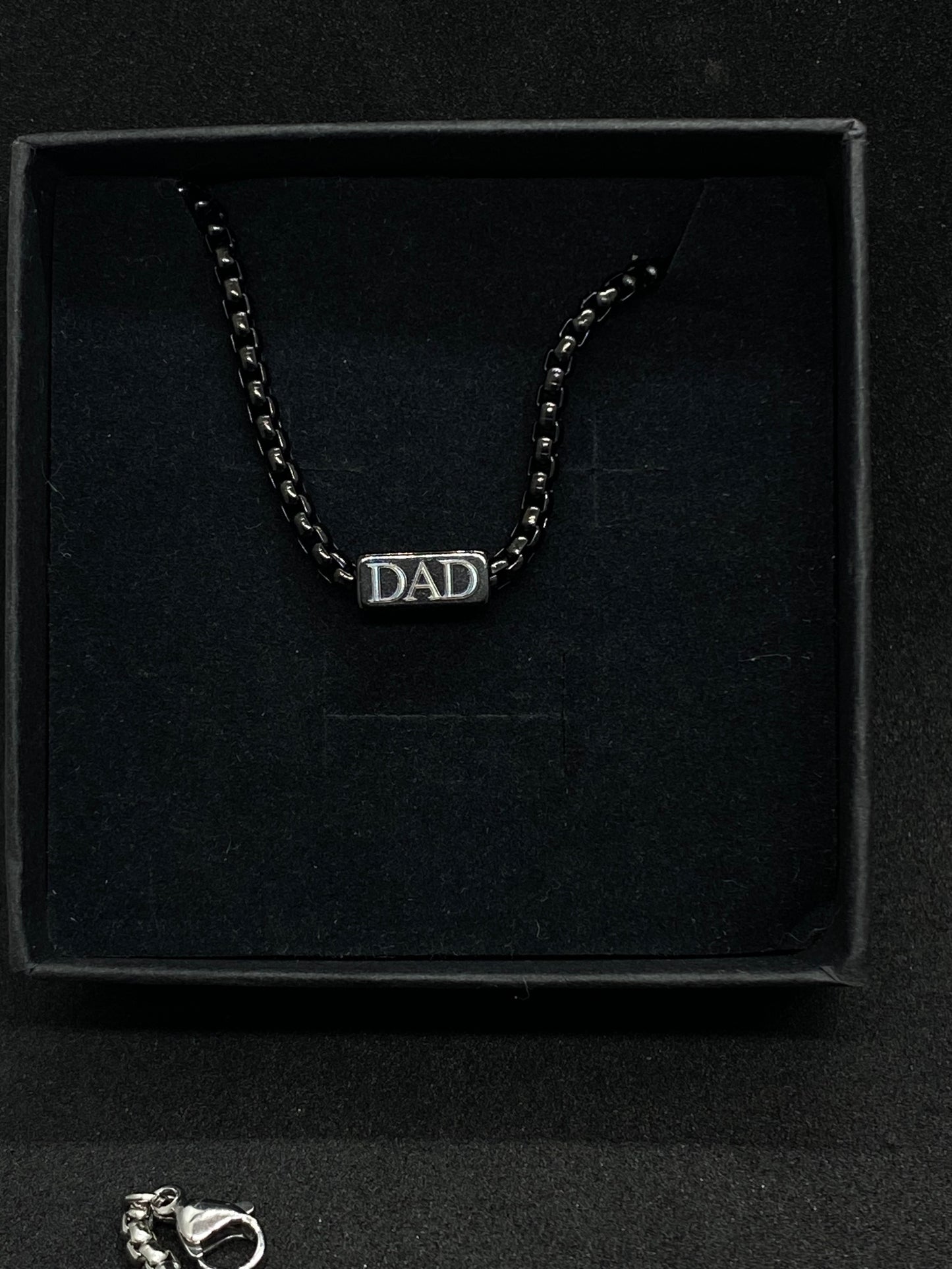 Bracelet with 'DAD' on a black box