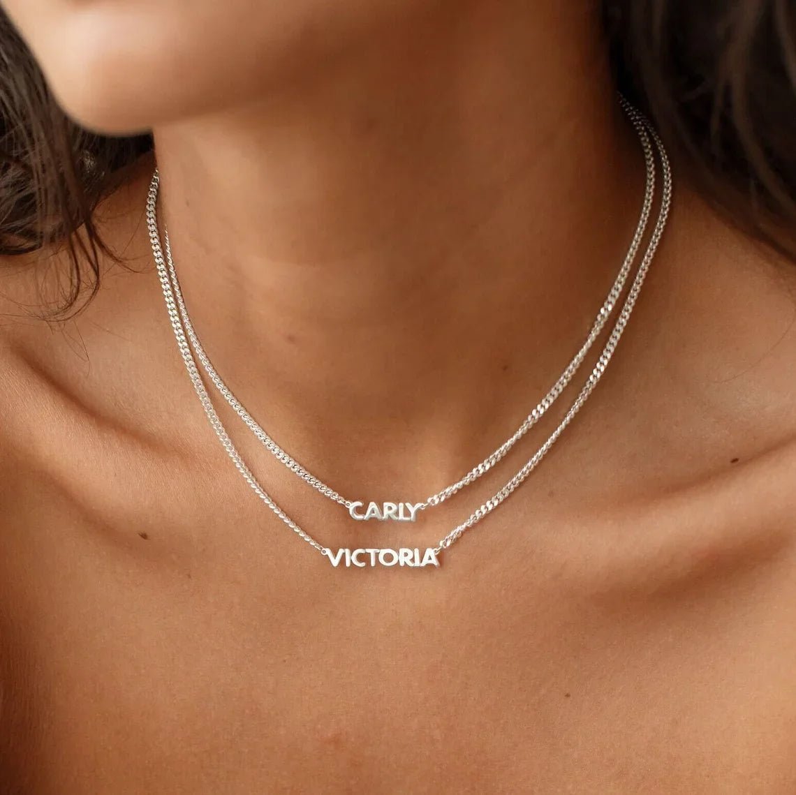 personalised name necklaces stacked in silver