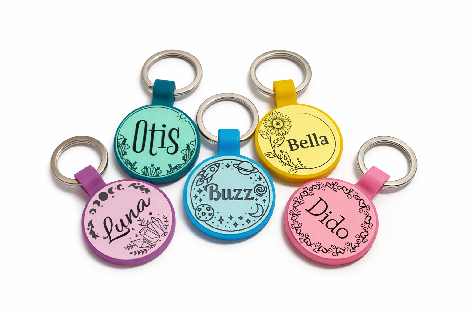Set of colorful pet tags with names engraved on a white background