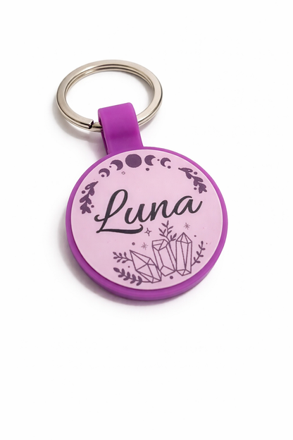 Purple pet tag with 'Luna' and crystal design on a white background