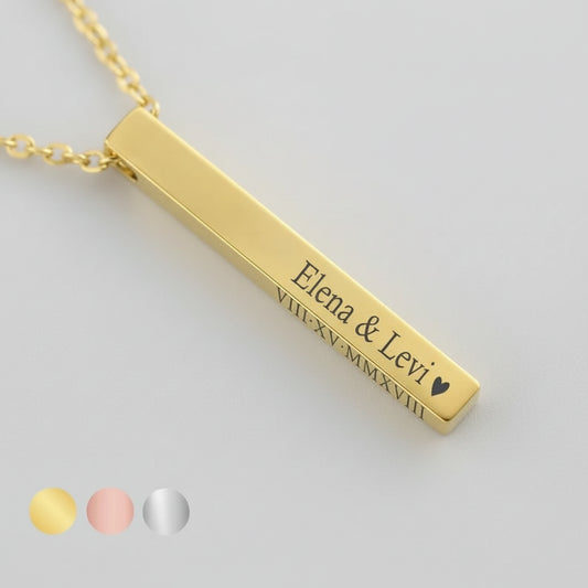 Gold bar necklace with engraved names on a light background