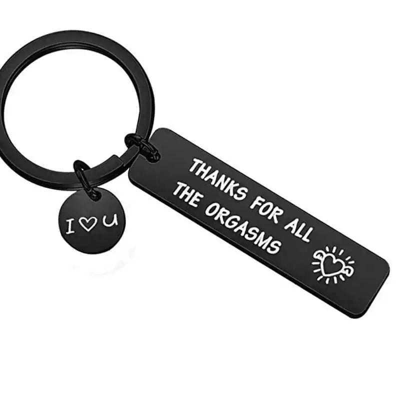 Black keychain with engraved text on a white background