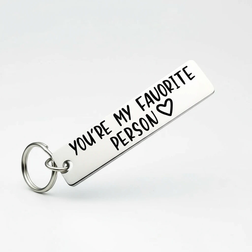 Keychain with 'You're My Favorite Person' text held between fingers