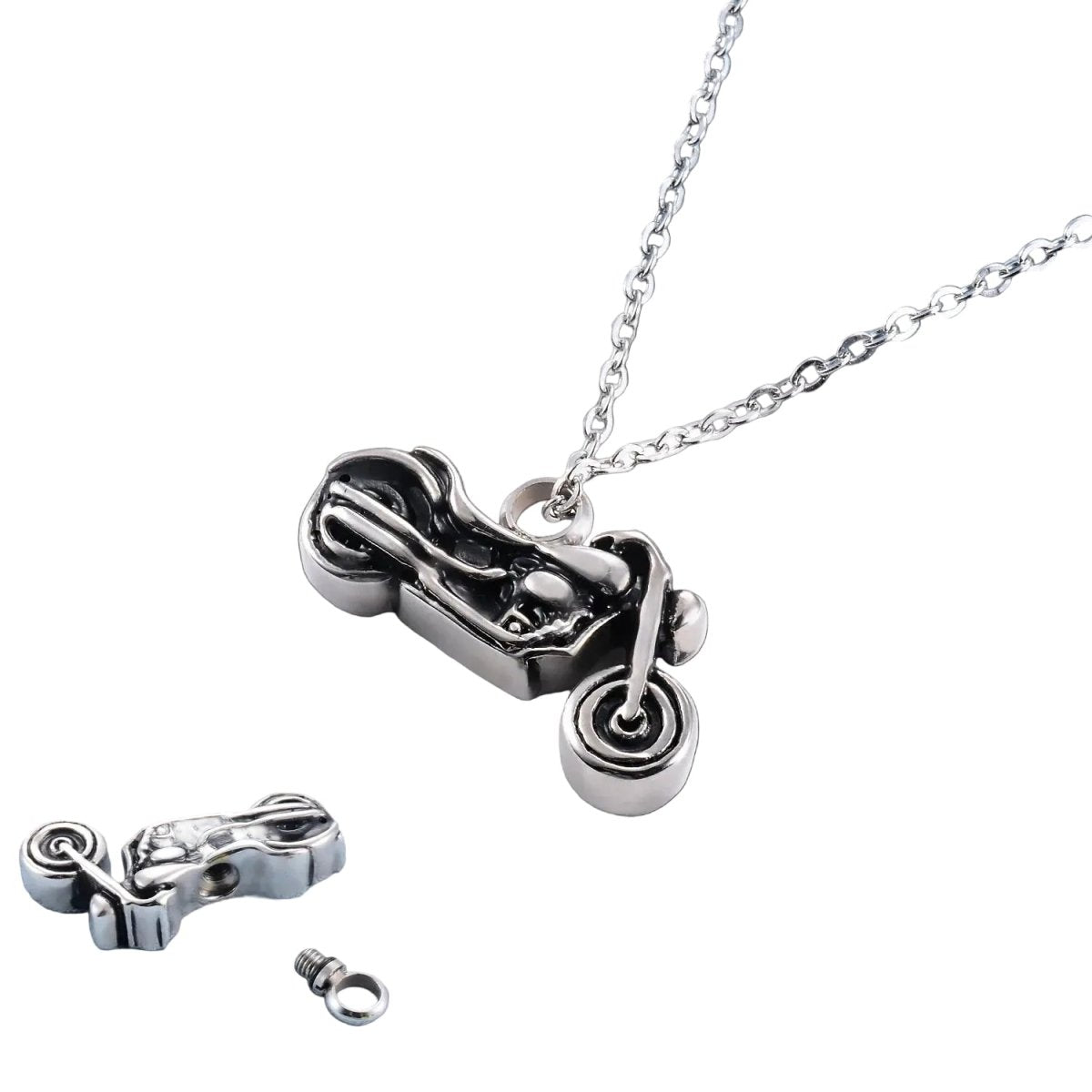 Motorcycle pendant necklace on a light blue fabric background