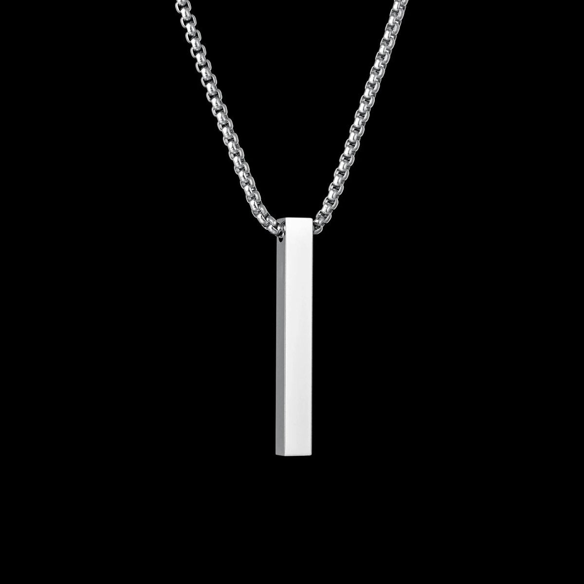 Silver necklace with a rectangular pendant on a black background