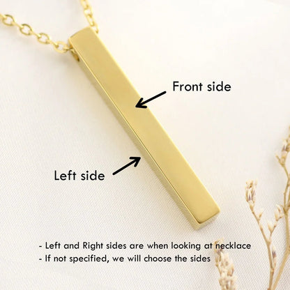 Gold necklace with a bar pendant on a light background