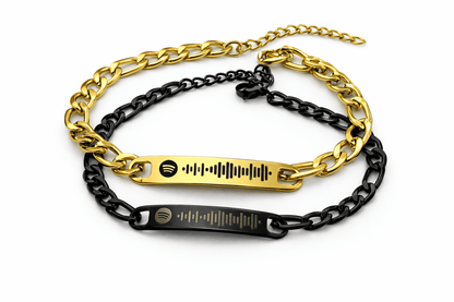 gold and black bracelets engraved with spotify code