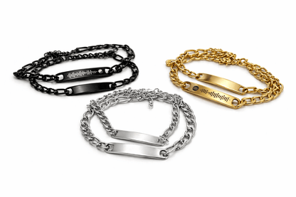 Three chain bracelets in black, silver, and gold on a white background