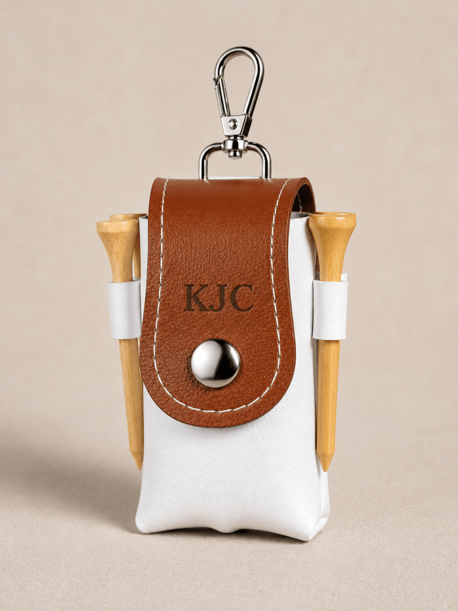 Golf tee holder with brown leather cover and wooden tees on a beige background